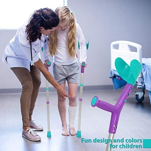 Child with bandaged leg using ORTONYX Tiki kids forearm crutches with adjustable arm support; clinician assisting
