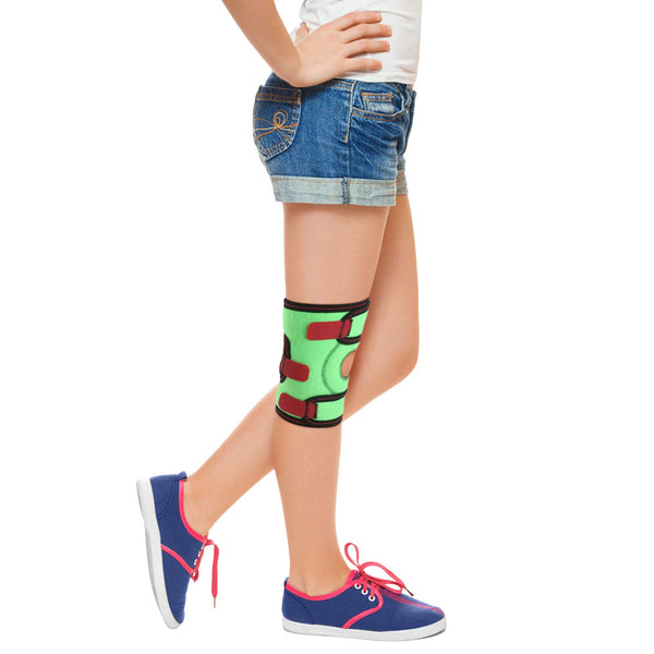 Child wearing ORTONYX Kids Knee Brace ACJB2110, green wrap with patella ring and hook-and-loop straps for pediatric support.