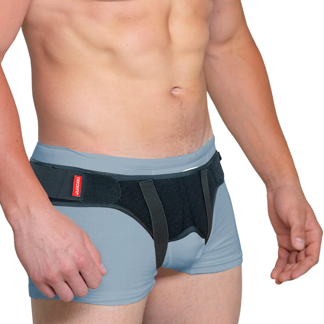 ORTONYX inguinal hernia belt truss on male model, dual removable pads and adjustable hook-and-loop straps for groin support.