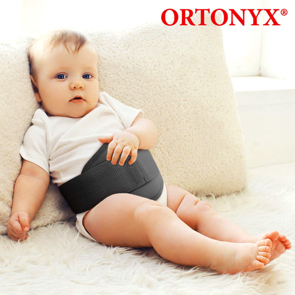 Infant wearing ORTONYX Baby Umbilical Hernia Belt OX350 with hook-and-loop closure, elastic support wrapped around abdomen.