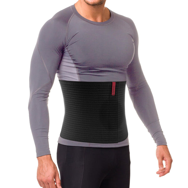 Man wearing black 10.25 in umbilical hernia belt abdominal binder, ribbed elastic wrap with red tag for navel ventral support