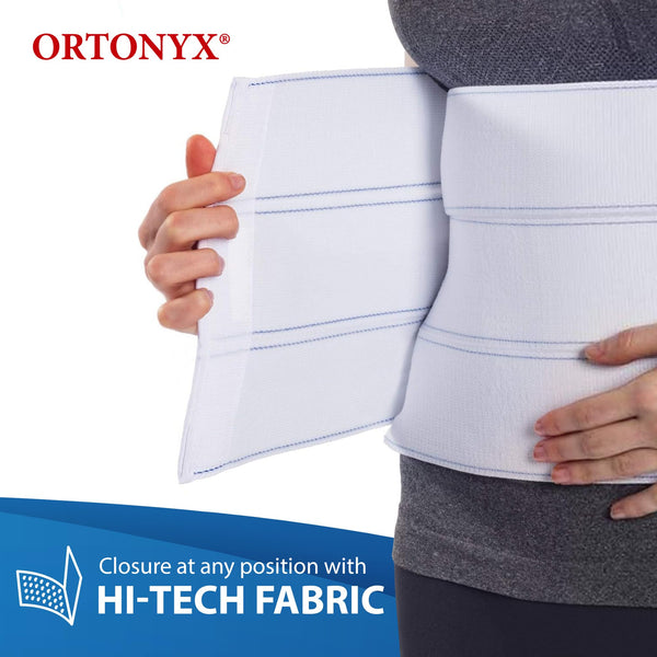 Person adjusting ORTONYX abdominal binder with hi-tech fabric closure; breathable postoperative umbilical hernia belt.