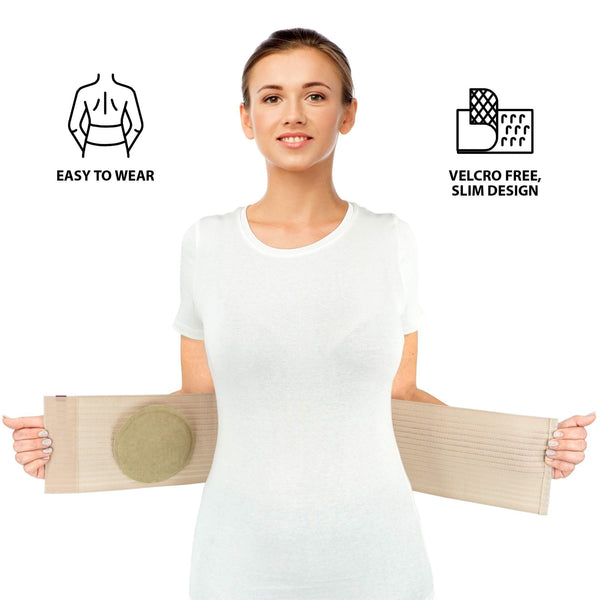 Model holding beige umbilical hernia belt open, showing removable silicone hernia pad; easy-to-wear, Velcro-free slim design.