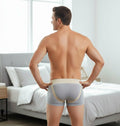 Man wearing low-profile bilateral inguinal hernia truss belt briefs with elastic waistband for discreet groin support