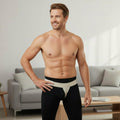 Model wearing inguinal hernia truss groin support belt with contoured front pad and adjustable hook-and-loop strap; discreet