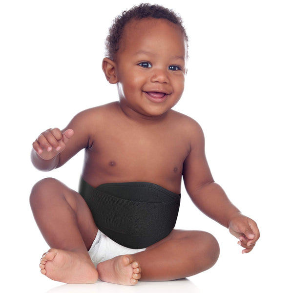 Baby wearing black ORTONYX umbilical hernia belt OX350, padded abdominal panel pediatric hernia truss supporting the navel.