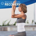 Breathable elastic abdominal binder on woman practicing yoga, wide postoperative compression support and umbilical hernia belt