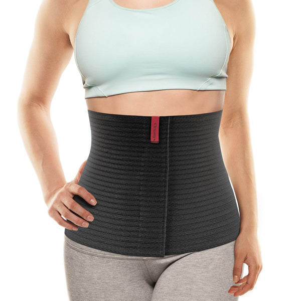 Black ORTONYX abdominal binder 524010 worn on waist, ribbed breathable elastic with front adjustable closure for compression.