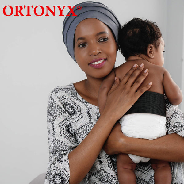 Infant wearing ORTONYX Baby Umbilical Hernia Belt OX350 VCOX350, black elastic abdominal band; pediatric hernia truss.