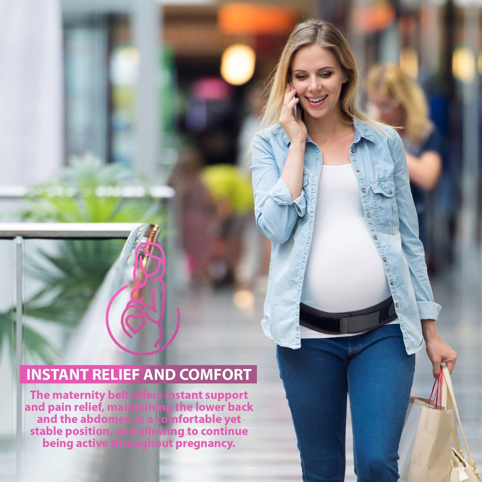 Pregnant woman in mall wearing black Maternity Support Belt, ORTONYX pregnancy brace, with hook-and-loop front panel.