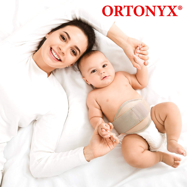 Infant wearing ORTONYX OX350 umbilical hernia belt; foam pad targets navel, elastic wrap with hook-and-loop closure.