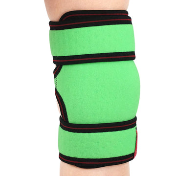 ORTONYX Kids Knee Brace ACJB2102 on child’s leg—green sleeve with elastic compression and hook‑and‑loop adjustable straps.