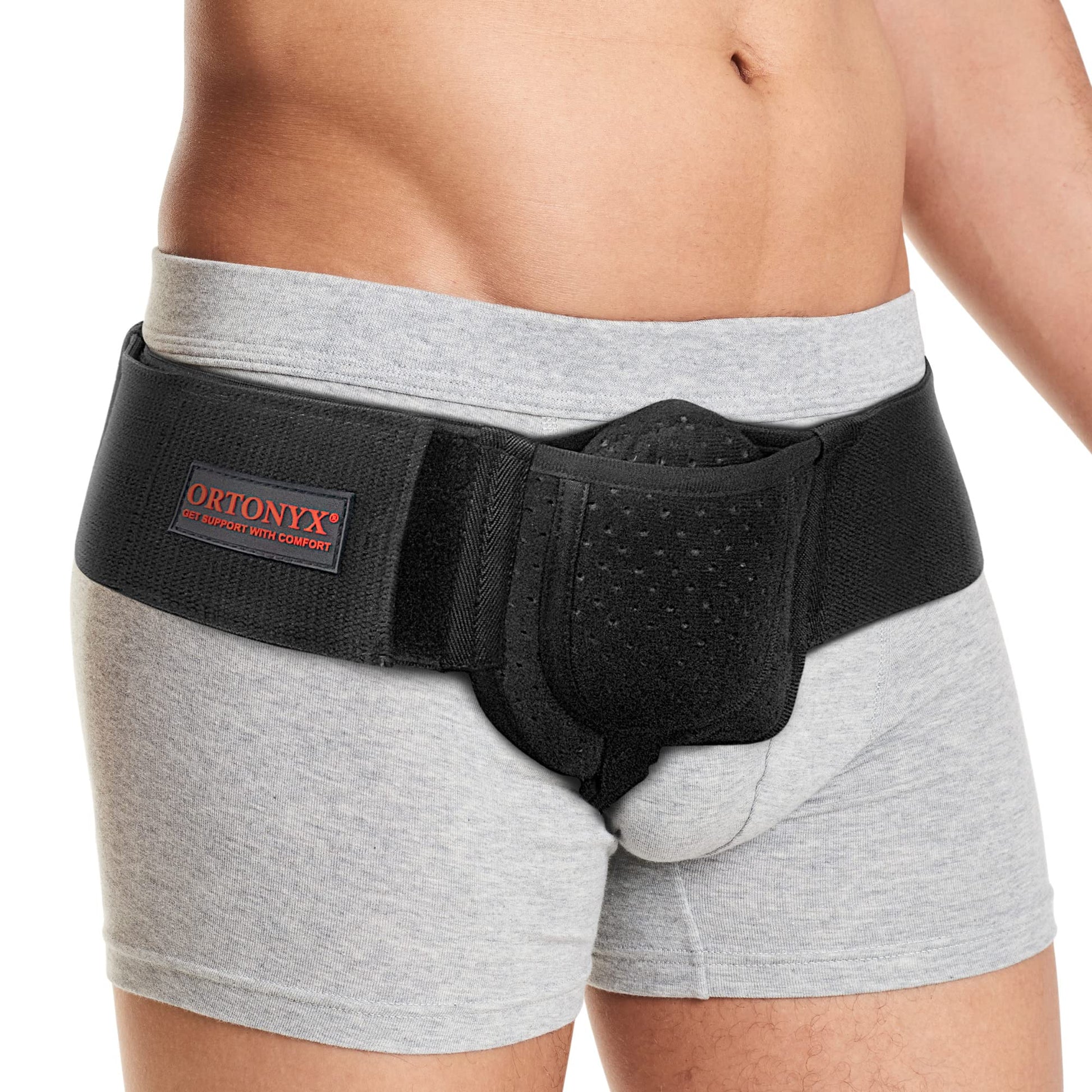 ORTONYX Inguinal Hernia Belt worn at waist; perforated groin pad and adjustable hook‑and‑loop strap for targeted support.
